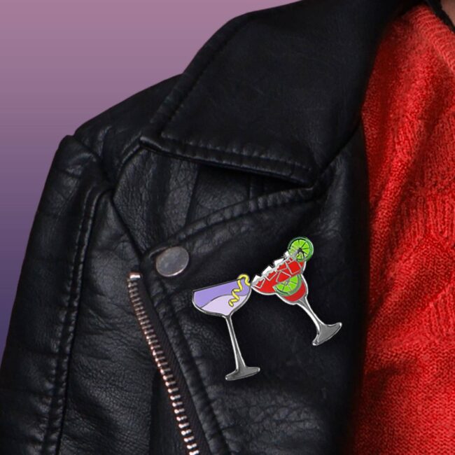 Margarita Cocktail Pin and Aviation cocktail pin clinking on a leather jacket lapel